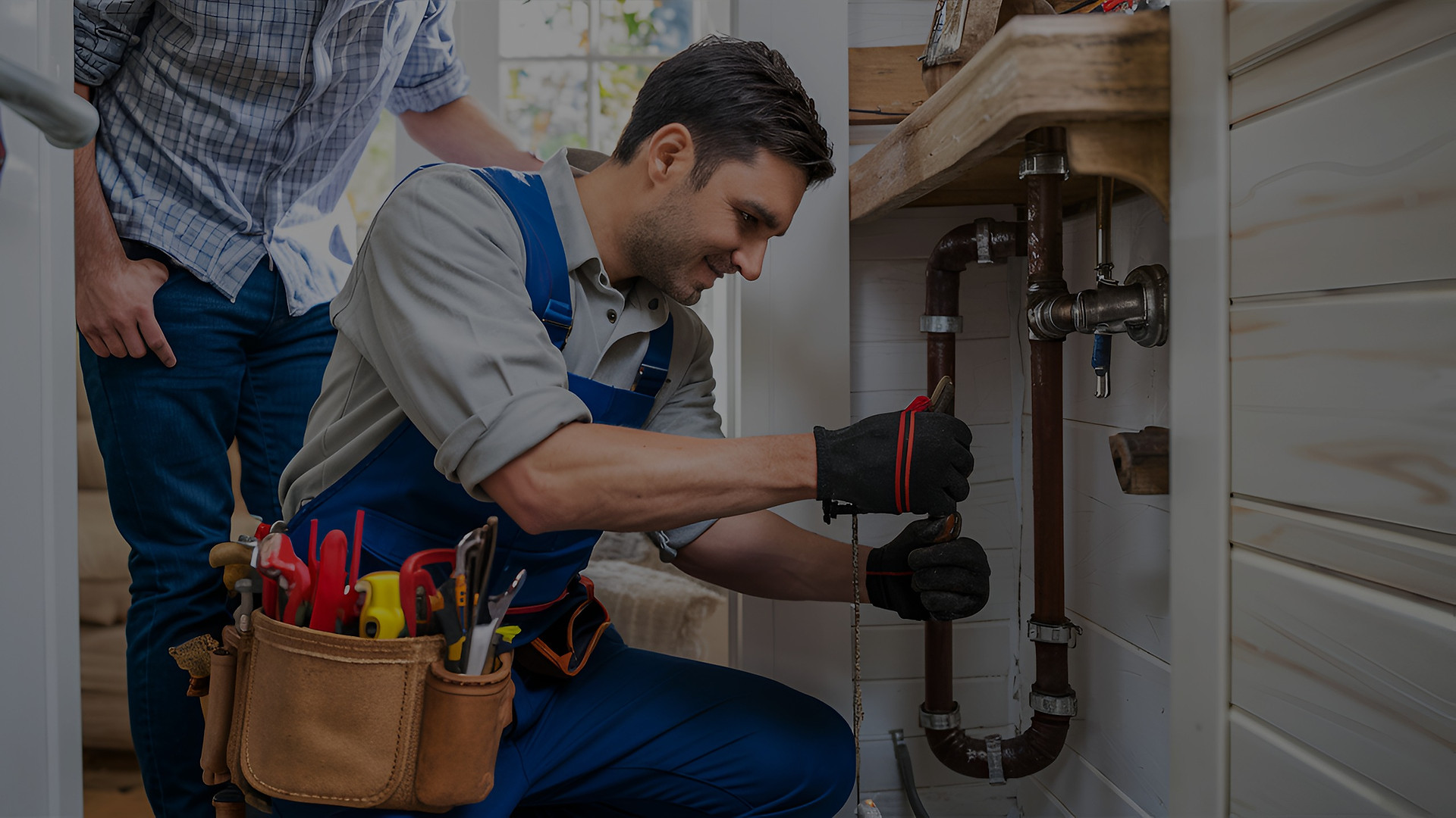 "Plumber repairing pipe in Jamaica, Queens, wearing tool belt with plumber's tools. Fast, reliable plumbing services for emergencies."